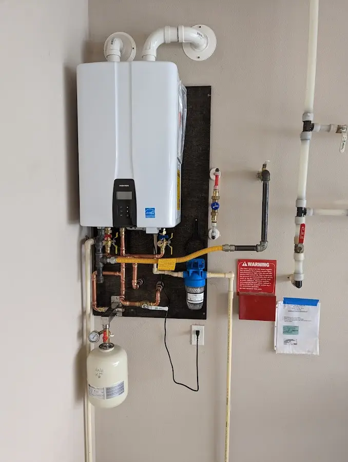 Professional plumber installing copper piping in a Worland home